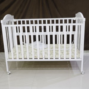 White wooden baby bed